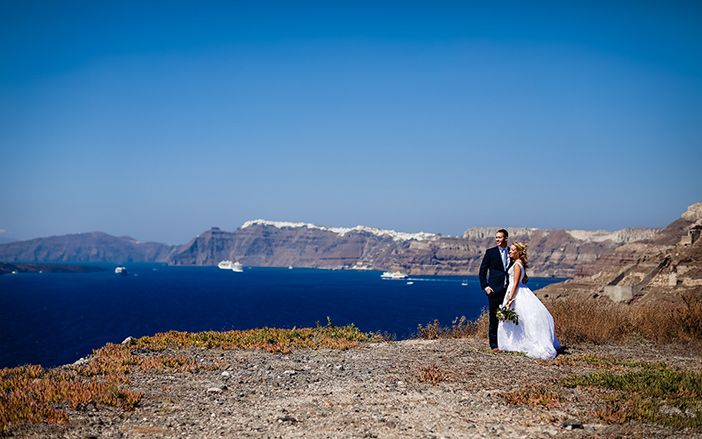 A bride and a groom gazing the view in Santorini island 