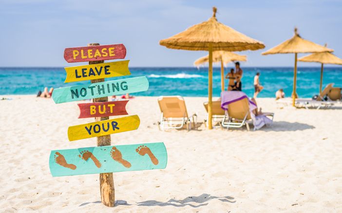 Please leave nothing but footprints sign in beach, Ikaria
